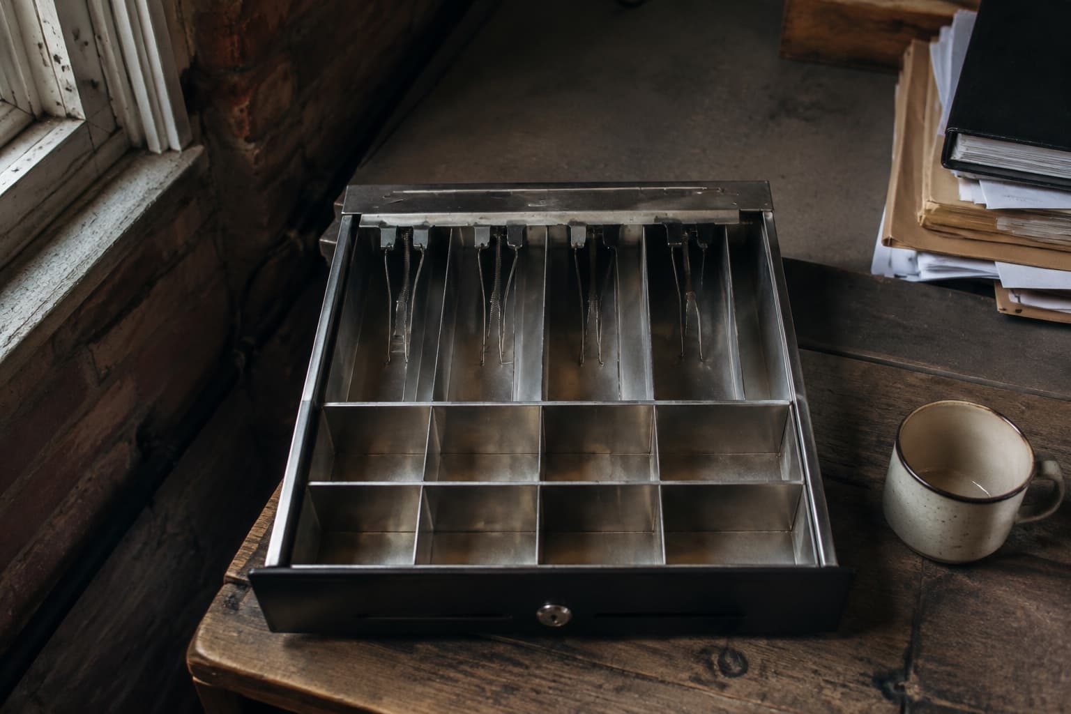 An empty till drawer with compartments for cash