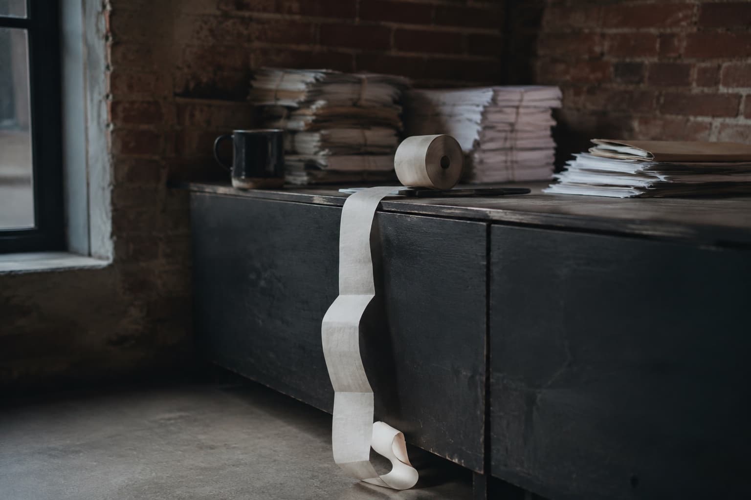 A till roll curling over the edge of a counter